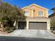 Two-story home with a two-car garage and landscaped front yard at 172 Tall Ruff Dr, Las Vegas, NV 89148