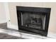 Cozy fireplace with black metal frame and tile surround in a living area with wood-style flooring at 2200 S Fort Apache Rd # 2189, Las Vegas, NV 89117