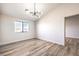 Bright bedroom with wood-look floors, modern chandelier, and spacious closet at 228 Yardarm Way, Las Vegas, NV 89145