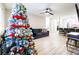 Decorated Christmas tree in a living room with a sectional sofa and light wood-look flooring at 244 N Bruce St # D, Las Vegas, NV 89101