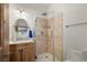 Bathroom with shower, vanity with wooden cabinet, and tile flooring at 2590 W Betty Ave, Pahrump, NV 89060