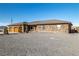 Stone and stucco exterior home with a three-car garage at 2590 W Betty Ave, Pahrump, NV 89060