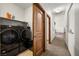 Laundry room with Samsung washer and dryer, and hallway leading to carpeted room at 2590 W Betty Ave, Pahrump, NV 89060