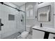 Modern bathroom with white tile, black fixtures, and a glass shower at 2895 Sunlit Glade Ave, Henderson, NV 89074