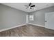 Spacious, well-lit bedroom with ceiling fan, wood-look tile floors, and white trim at 2895 Sunlit Glade Ave, Henderson, NV 89074