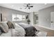 Primary bedroom with ensuite bathroom, ceiling fan, and view of the backyard at 2895 Sunlit Glade Ave, Henderson, NV 89074