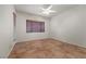 Spacious bedroom with tile flooring, large windows with blinds, and neutral walls at 3218 Squire St, Las Vegas, NV 89135