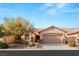 Single-story house with tan exterior, two-car garage, and landscaping at 3639 Halter Dr, Las Vegas, NV 89122