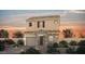 Charming two-story home with stone accents, shutters, and a tiled roof at sunset at 377 Silva Pl, Henderson, NV 89011