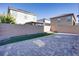 Backyard of home with patio, grass and neighboring houses visible over the wall at 4088 Scarlet Cob Ave, Las Vegas, NV 89141