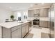 Modern kitchen featuring stainless steel appliances, a large island, and gray shaker cabinets at 4088 Scarlet Cob Ave, Las Vegas, NV 89141