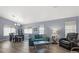 Bright and spacious living room featuring hardwood floors, a sofa, and a dining area at 5683 Whale Watch St, Las Vegas, NV 89113