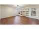 Living room with built-in shelves, wood floors, a ceiling fan, and natural light at 932 Sweeping Vine Ave, Las Vegas, NV 89183