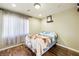 Bright bedroom with wood floors and a comfortable bed at 10042 Pipestone St, Las Vegas, NV 89141