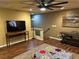 Living room with hardwood floors, large TV, and a view of the upstairs at 10042 Pipestone St, Las Vegas, NV 89141