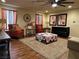 Living room with hardwood floors, red armchairs, and a crocheted blanket at 10042 Pipestone St, Las Vegas, NV 89141