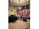 Home office with Hawaiian decor, flags, musical instruments, and a chandelier at 10042 Pipestone St, Las Vegas, NV 89141