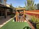 Patio with pergola, seating area, and artificial turf at 10042 Pipestone St, Las Vegas, NV 89141