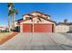 Two story house with a three car garage and landscaped yard at 164 Herbie Ln, Henderson, NV 89015