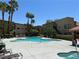 Inviting community pool with lounge chairs, palm trees, and a hot tub at 1856 N Decatur Blvd # 104, Las Vegas, NV 89108