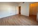 Empty bedroom with wood floors, open closet, and an adjacent bathroom at 2041 Hussium Hills St # 108, Las Vegas, NV 89108