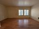 Living room with wood-look floors, large windows, and white walls at 2041 Hussium Hills St # 108, Las Vegas, NV 89108