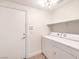 Bright laundry room with washer, dryer and shelving at 2287 Dakota Sky Ct, Henderson, NV 89052