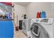 Laundry room with washer, dryer, and storage shelves at 260 E Desert Rose Dr, Henderson, NV 89015