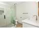 Modern bathroom with a white quartz vanity and herringbone tile shower at 3575 Tioga Way, Las Vegas, NV 89169