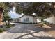 Modern home with clean lines and a large driveway, surrounded by lush landscaping at 3575 Tioga Way, Las Vegas, NV 89169