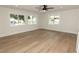 Spacious living room featuring wood-look floors and large windows at 3575 Tioga Way, Las Vegas, NV 89169