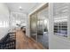 Bright entry hall with wood floors, bench, and view into kitchen at 4000 Statuary St, Las Vegas, NV 89141