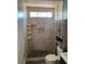 Bathroom with tiled shower, vanity, and toilet, featuring natural light at 4454 Bertram Ln, Las Vegas, NV 89147