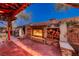 Brick outdoor fireplace with wood storage and seating at 4804 Boone St, North Las Vegas, NV 89031