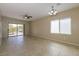 Spacious living room with tile flooring, a ceiling fan, and sliding glass doors to the backyard at 6065 Corbin Ave, Las Vegas, NV 89122