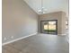 Bright living room with vaulted ceilings, wood-look flooring, and sliding glass doors to backyard at 6316 W Gowan Rd, Las Vegas, NV 89108