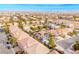 Aerial view of a residential neighborhood, featuring a house with a pool and solar panels at 6585 Coronado Crest Ave, Las Vegas, NV 89139