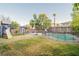 Landscaped backyard with a swimming pool, playground, and basketball court at 6585 Coronado Crest Ave, Las Vegas, NV 89139