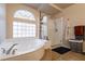 Bathroom boasts a large soaking tub, shower, and updated window at 6585 Coronado Crest Ave, Las Vegas, NV 89139