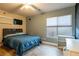 Bright bedroom with a double bed, window, and built-in shelves at 6585 Coronado Crest Ave, Las Vegas, NV 89139