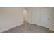 Empty bedroom featuring tile flooring, white walls, and closet doors at 6767 Warthog Ave, Las Vegas, NV 89156