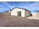 Back exterior of a single-story home with sliding glass doors and a fenced yard at 6767 Warthog Ave, Las Vegas, NV 89156