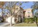 Two-story house with beige exterior, attached garage, and landscaped yard at 9112 Eagle Ridge Dr, Las Vegas, NV 89134