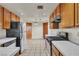 Efficient kitchen with wood cabinets and white countertops at 918 Ambusher St, Henderson, NV 89014