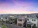 Modern townhomes at dusk in a new housing community at 11820 Pelican Butte Ave, Las Vegas, NV 89138