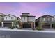 Modern townhomes with two-car garages at dusk at 11820 Pelican Butte Ave, Las Vegas, NV 89138