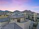 View of the rooftop of a modern townhome at dusk at 11820 Pelican Butte Ave, Las Vegas, NV 89138