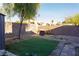 Backyard with grass, gravel, brick wall, patio furniture, and a tree at 1302 Capri Dr # B, Boulder City, NV 89005