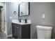 Bathroom with dark vanity, double sinks, and gray floor at 1440 Vegas Valley Dr # 3, Las Vegas, NV 89169