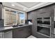 Sleek kitchen featuring dark cabinetry, stainless steel appliances, and city views at 205 E Harmon Ave # 1012, Las Vegas, NV 89169